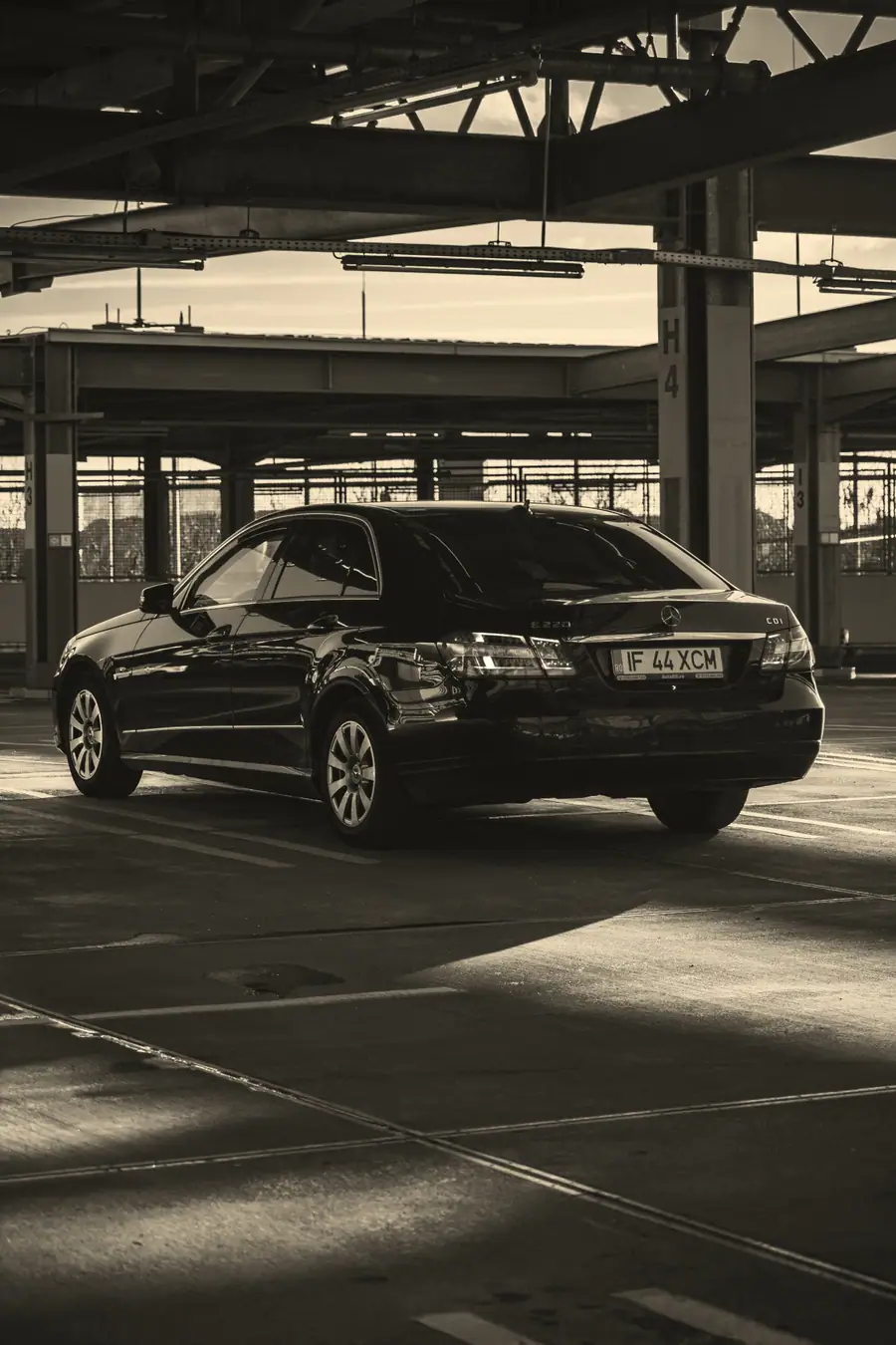Black Mercedes-Benz E-Class in a car park.